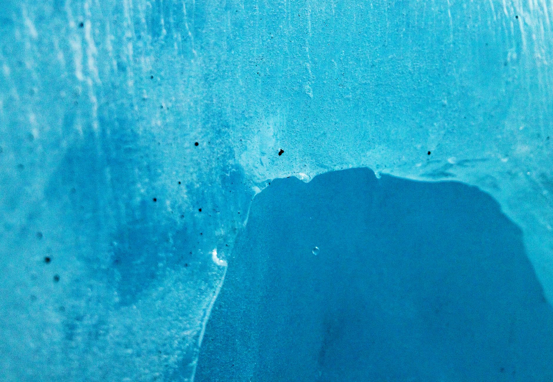 Detailed shot of a beautiful blue ice formation showcasing natural textures.