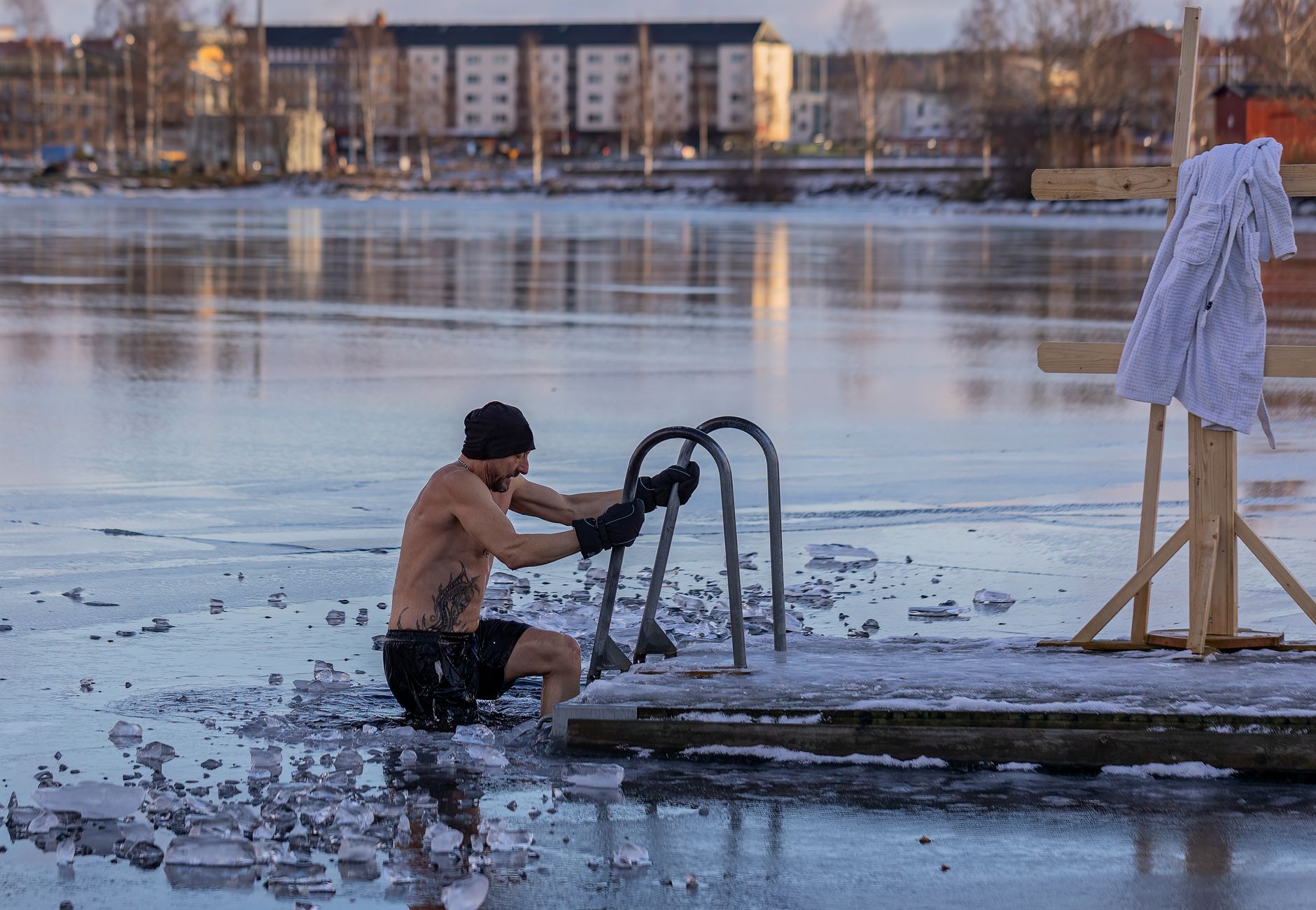 Shirtless man in freezing lake near Ludvika, Sweden, captured during a winter swim. Sublime ice scenery.